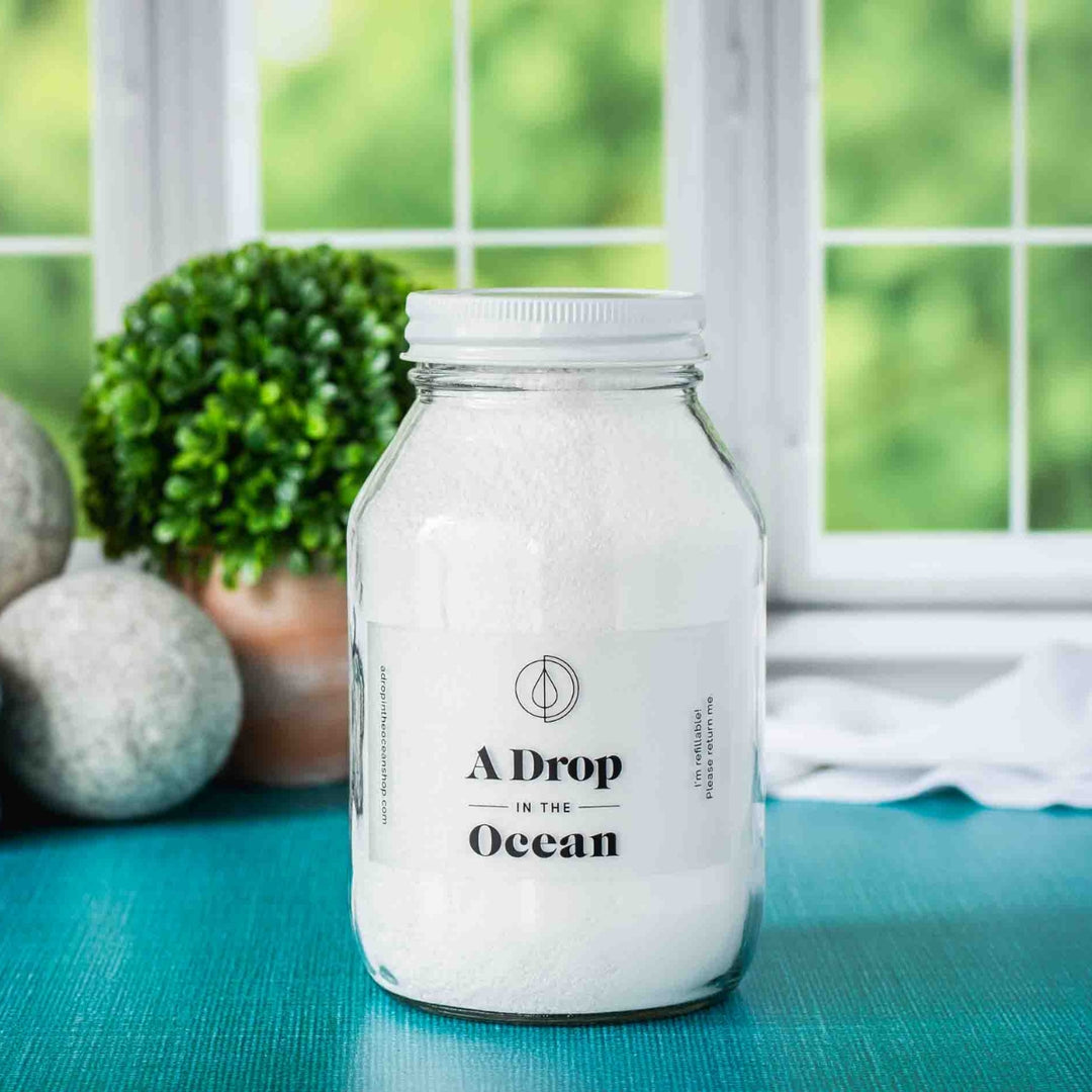 32oz jar of refillable laundry detergent in a glass jar