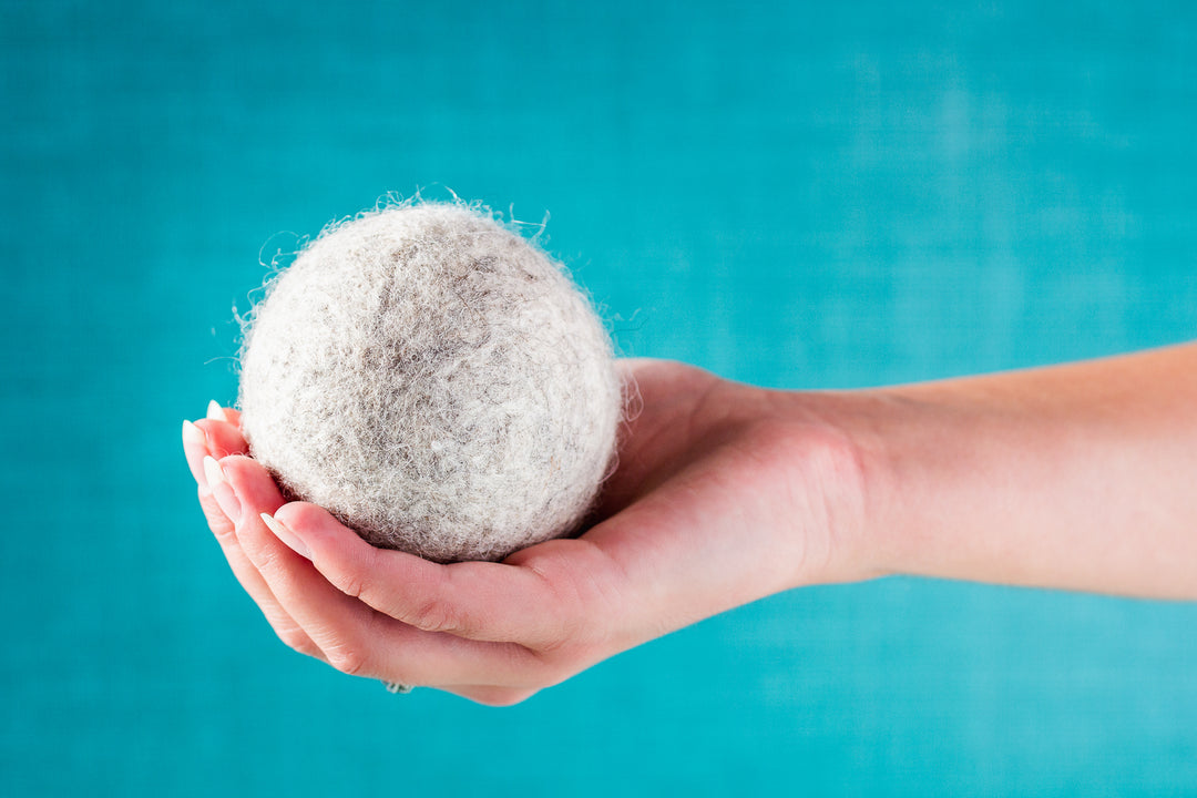 A Drop in the Ocean Zero Waste Store Reusable Wool Dryer Ball held in hand